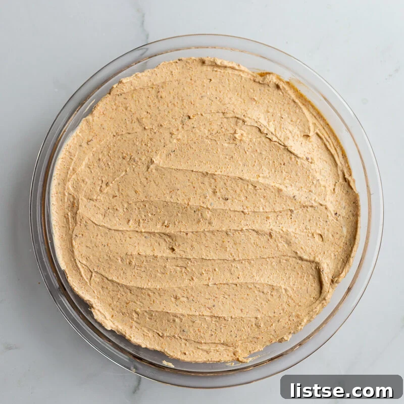 Cream Cheese Taco Dip Recipe for Parties 8 cream cheese smeared in the bottom of a pie dish